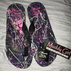 Pink and black Muddy Girl flip flops.